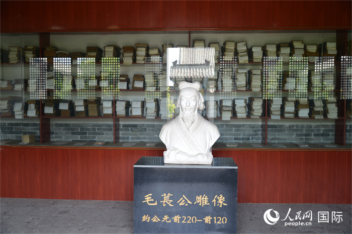 河間詩經齋毛萇雕像。雕像后書櫥中陳列的是歷代各版本《詩經》及譯本。 人民網 趙昭攝