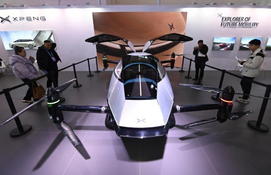 2023年12月1日，在鏈博會智能汽車鏈展區小鵬汽車展臺，參觀者觀看一臺智能飛行器。新華社記者蔡湘鑫攝