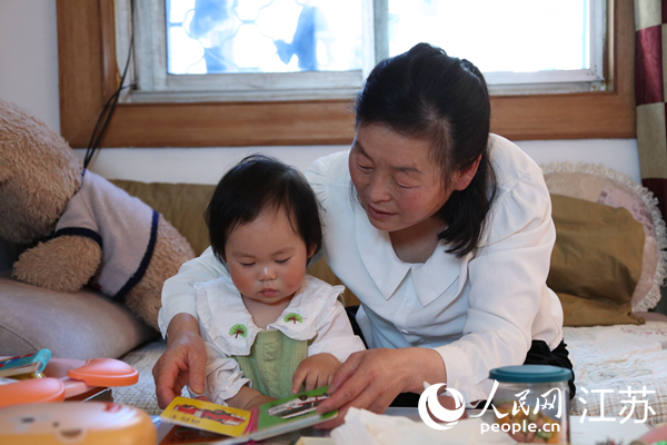 王繼蓮帶孫女看童書。人民網 冷金明攝